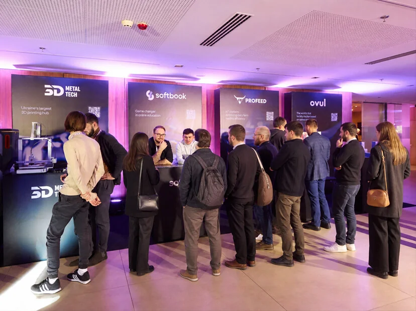 The Softbook stand at a tech expo: visitors talking to the team